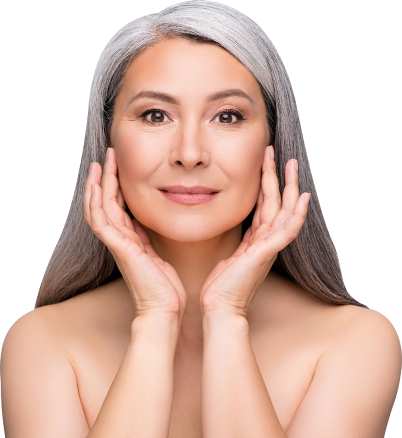 Smiling woman with gray hair holding her face with both hands