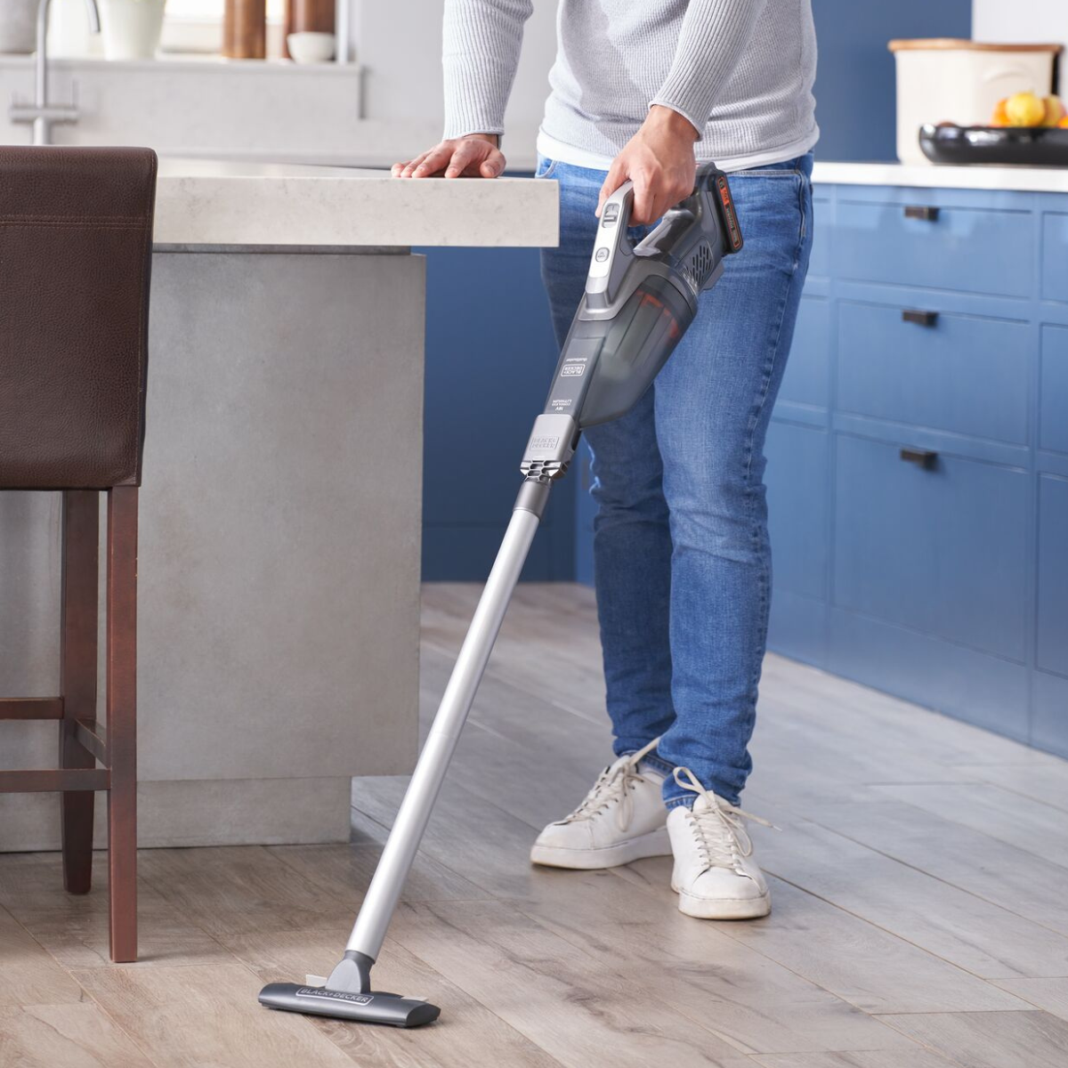 man using powerconnect hand vacuum with attachment to clean floors