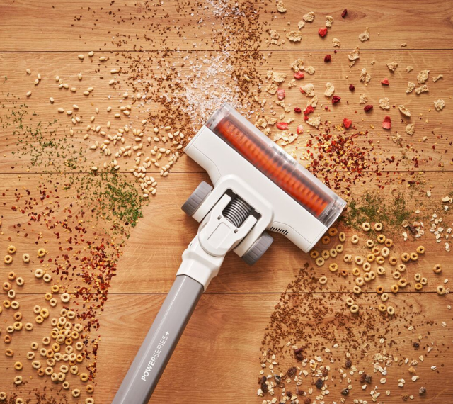 POWERSERIES Cordless Stick Vacuum being used to clean mess on a floor.