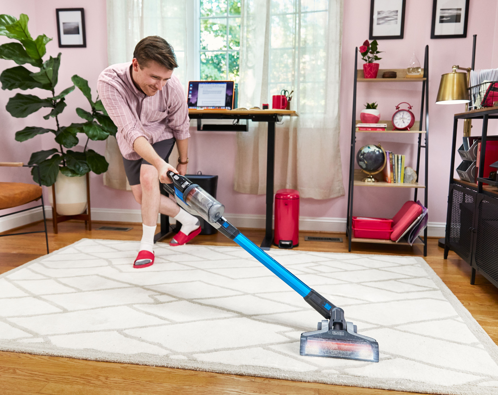 man dancing while cleaning with BLACK+DECKER PowerseriesExtreme stick vacuum