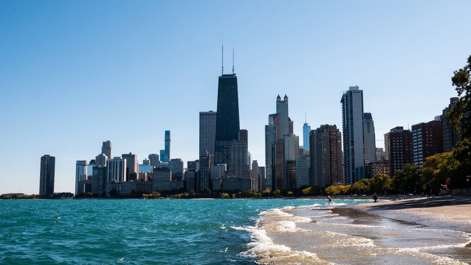 Chicago skyline and lakefront beach to represent where to buy e-bikes in Illinois