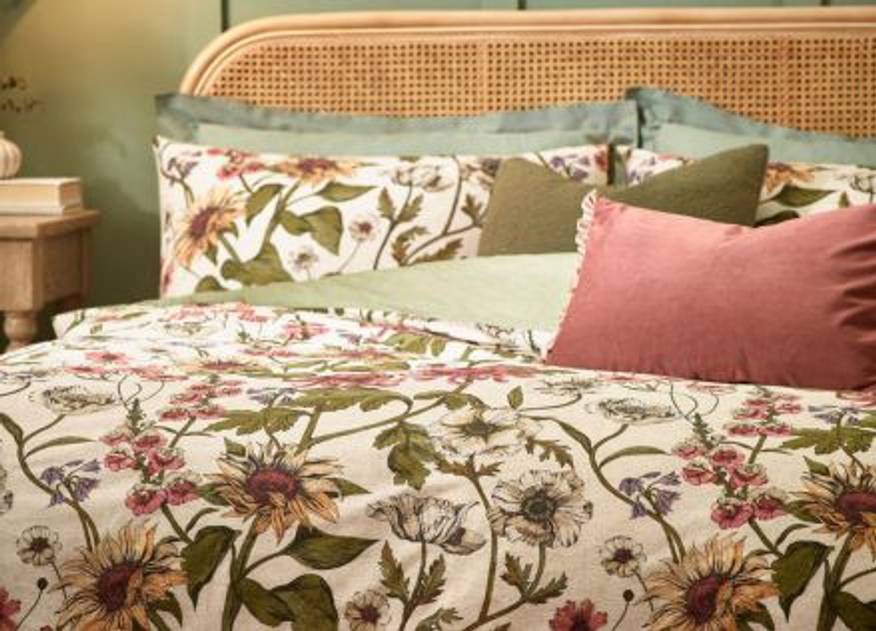 floral bedding with pink and green cushions