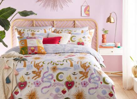 bright multicoloured bedding in a pink bedroom