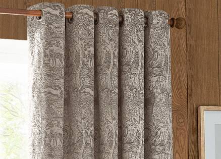grey eyelet curtains on a wooden pole