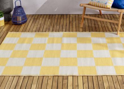 A rug with yellow and white check design