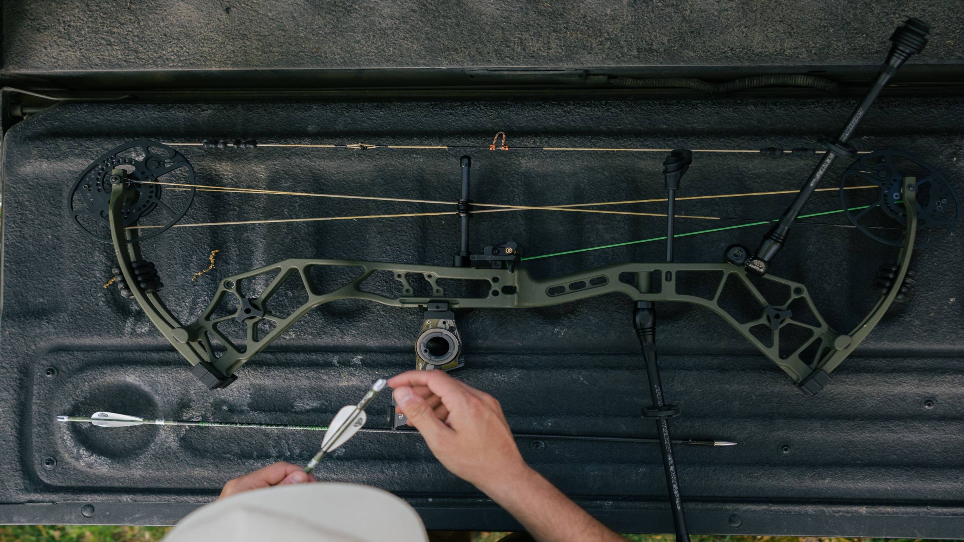 Image showcasing a full view of the Bear Alaskan XT compound bow on the back of a tailgate.