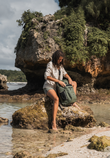 Woman with Adventure Waterproof Backpack in Olive Green.