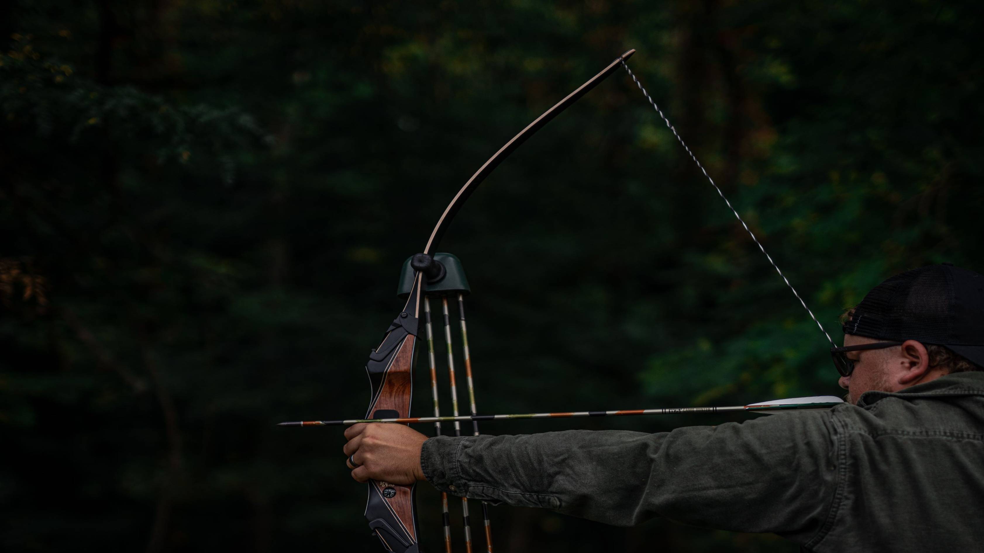 Man shooting an arrow with Bear Archery Take Down Longbow Limbs