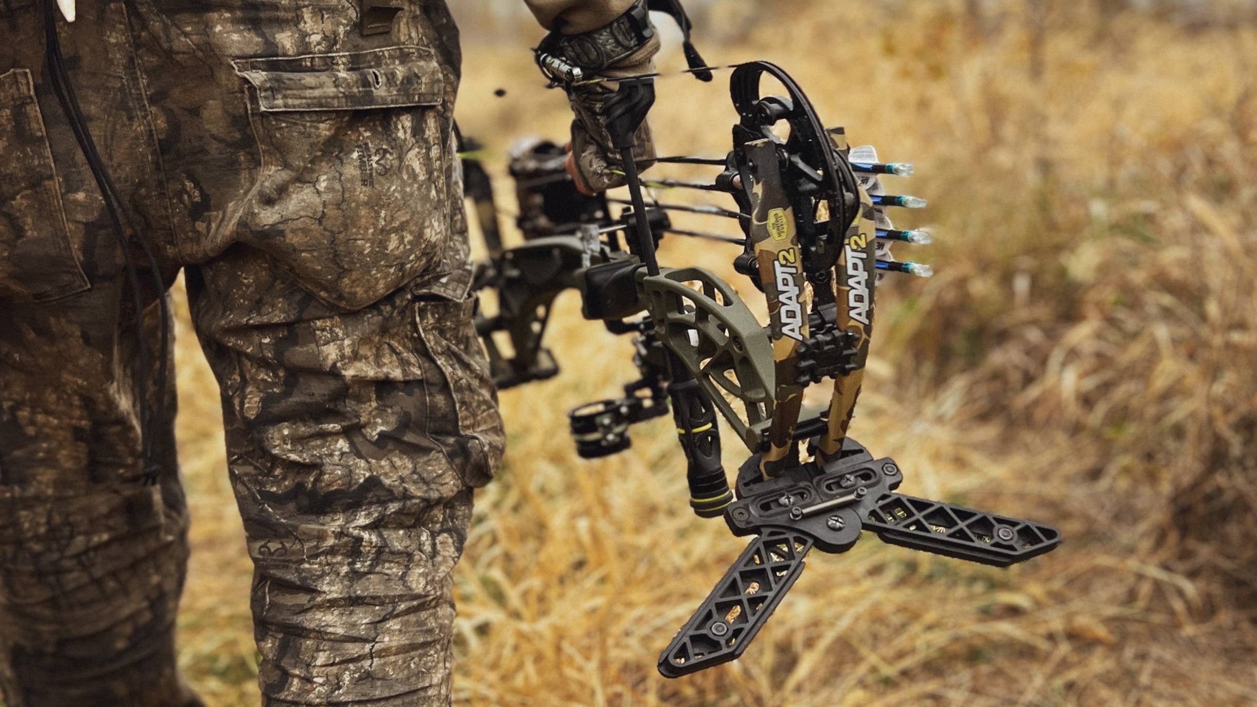 Bear Archery Adapt 2 RTH single cam compound bow created in collaboration with The Hunting Public being carried through a field.