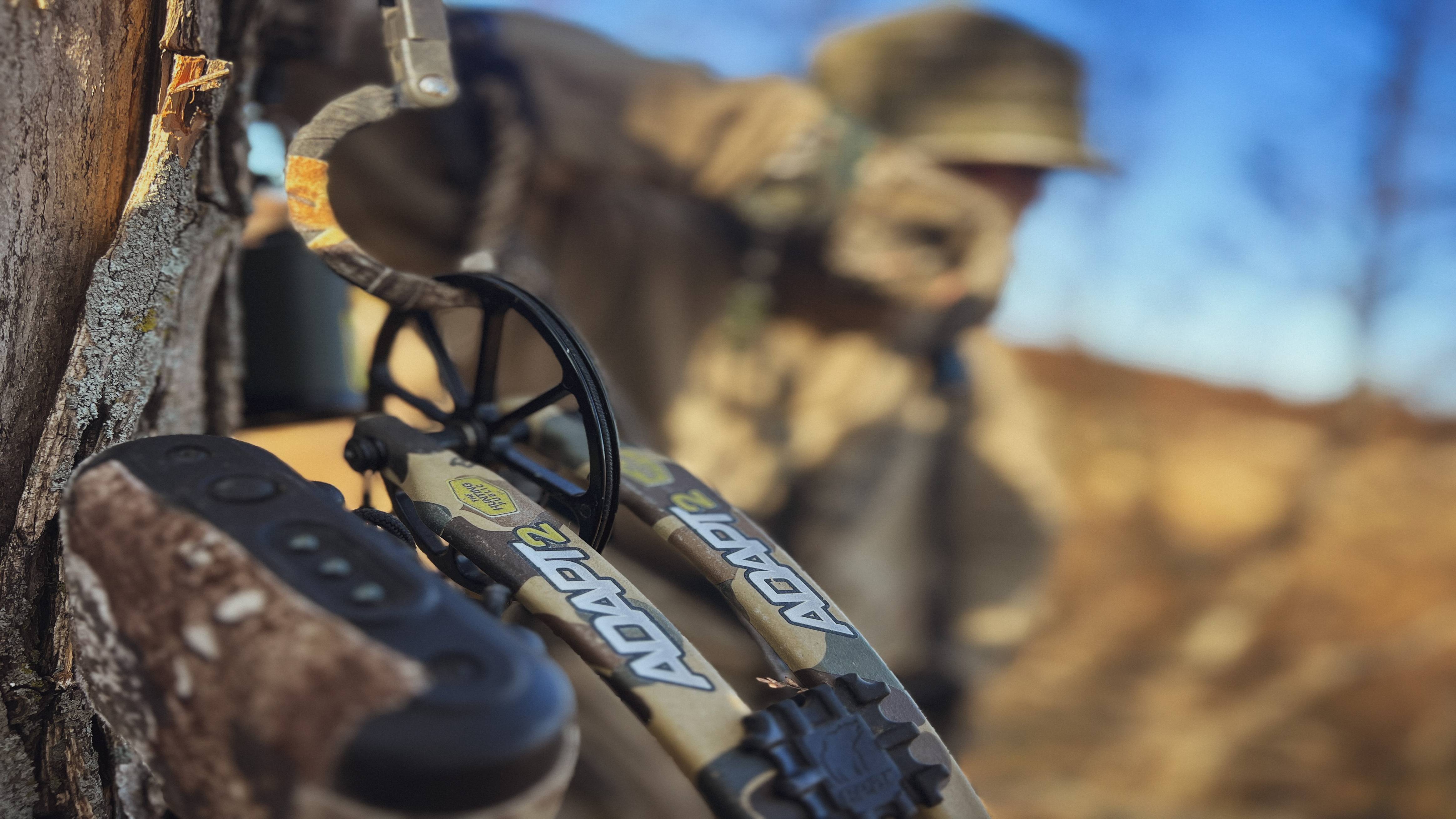 Bear Archery Adapt 2 RTH single cam compound bow created in collaboration with The Hunting Public hanging in a tree stand.