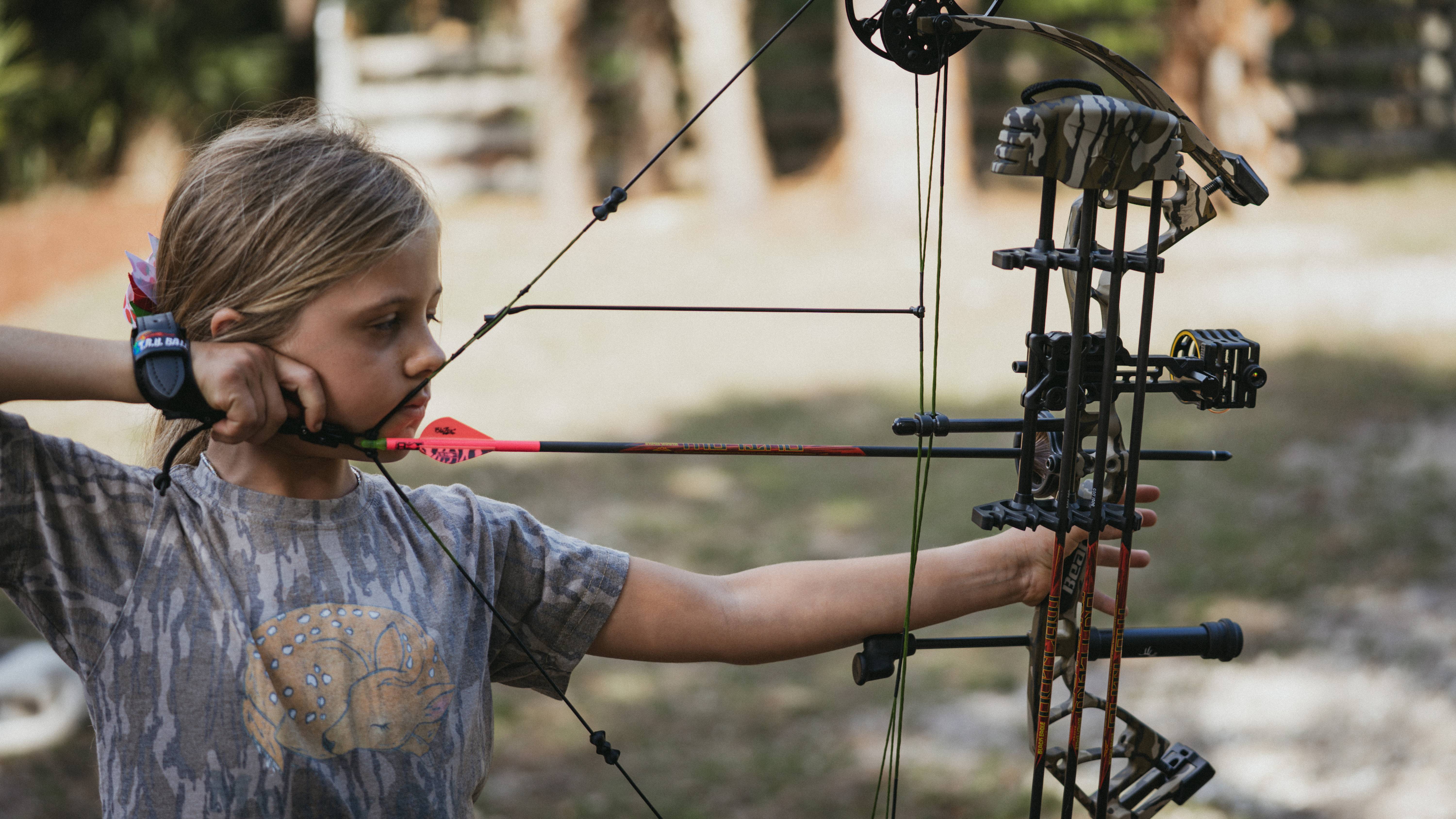 Young girl drawing a Bear Archery Gamekeeper Jr Compound Bow