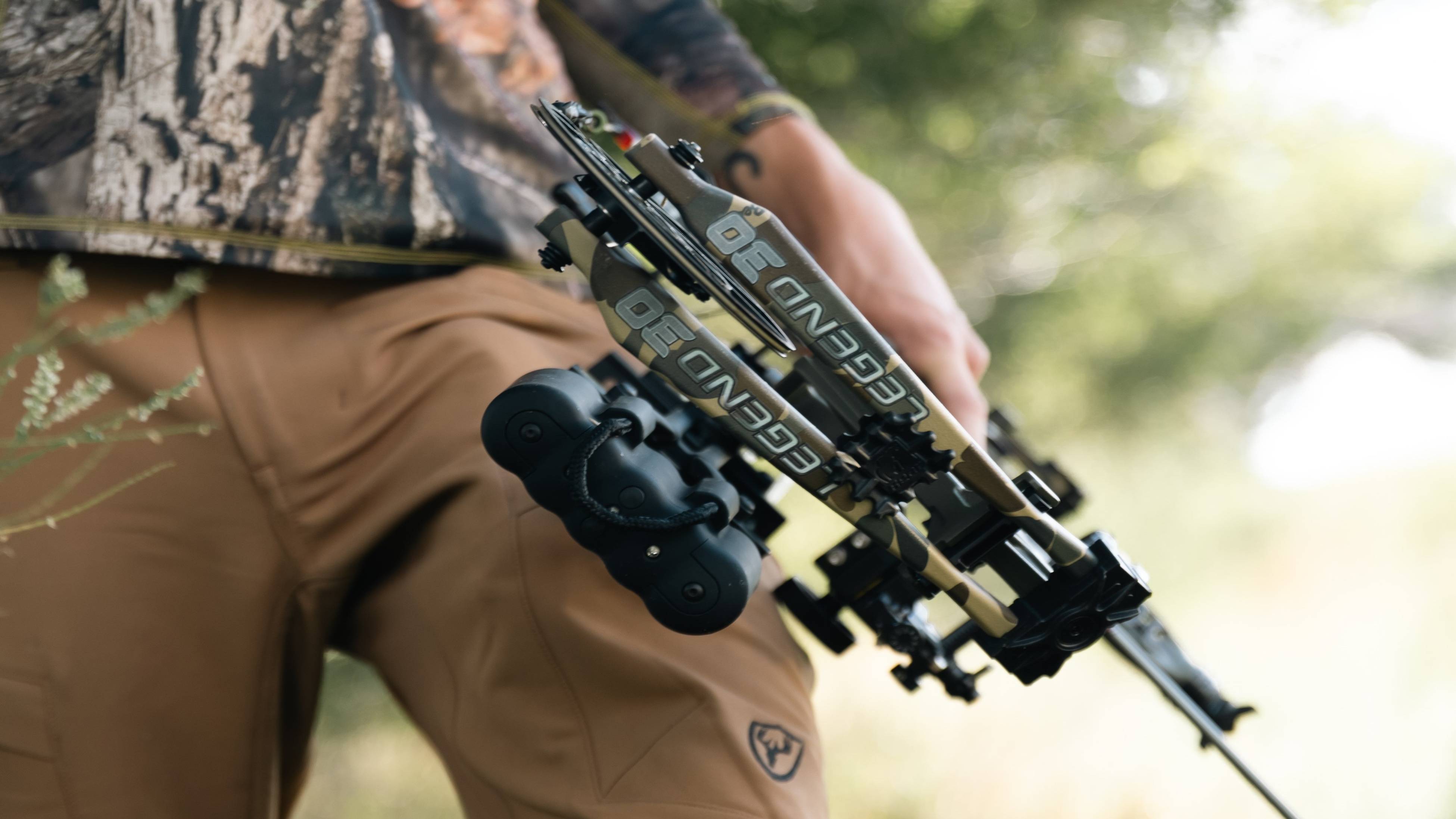 Man carrying a Bear Archery Legend 30 RTH Compound Bow