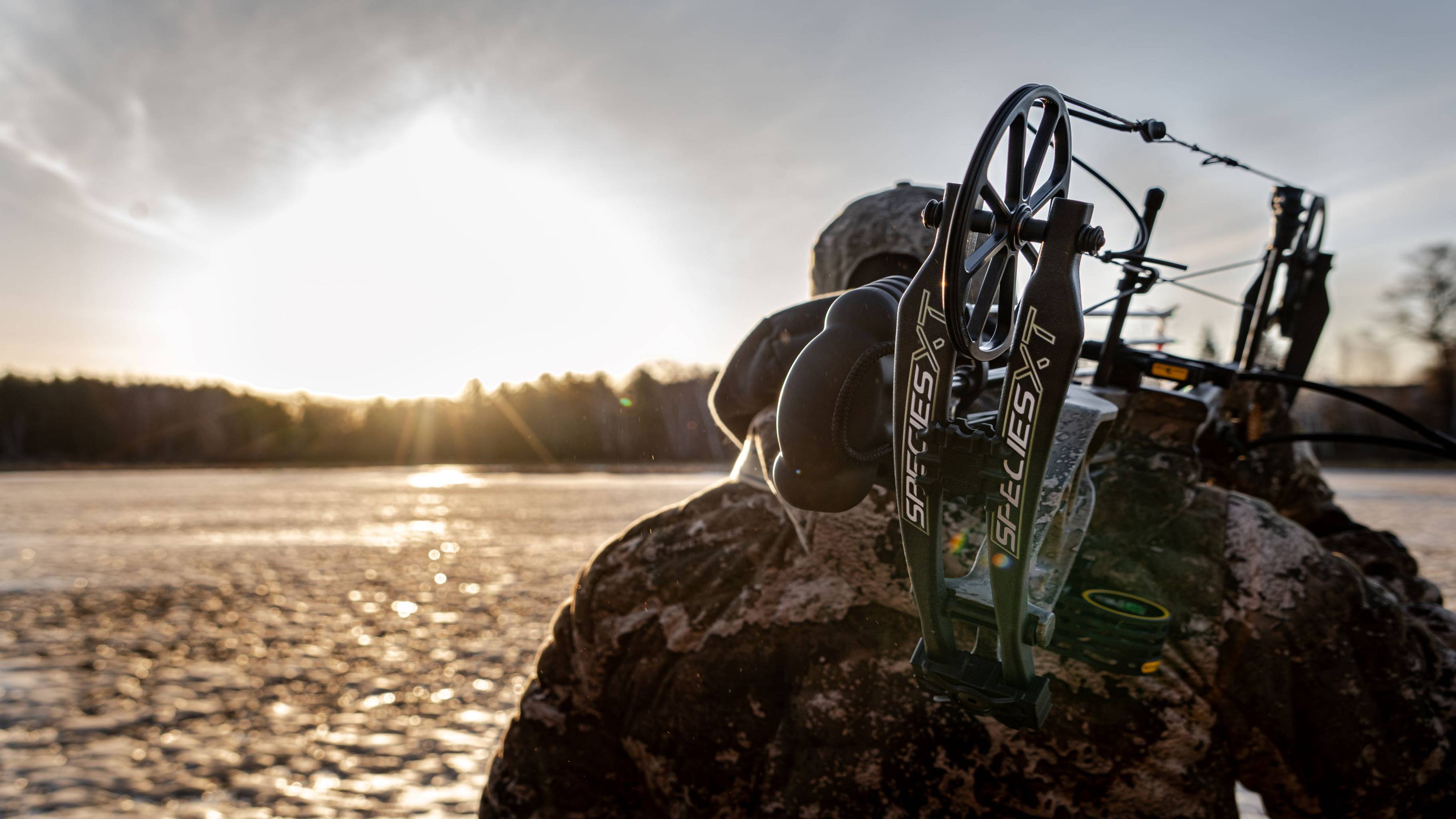 Man on the water with a Bear Archery Species XT Compound Bow over his shoulder