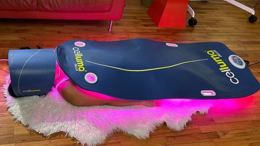 Women laying on rug with the Celluma PRO and DELUX getting an aging treatment.