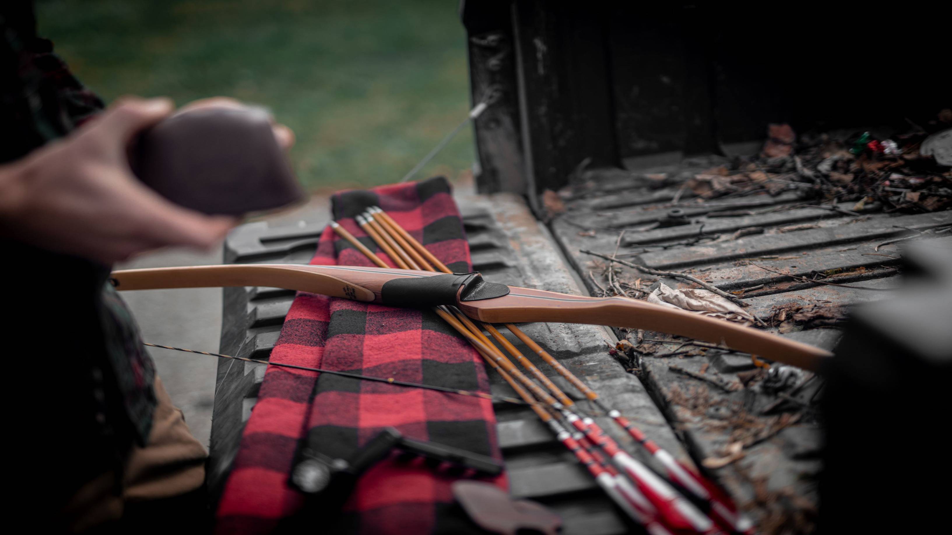 Bear Archery Au Sable Longbow laying on the bed of a truck