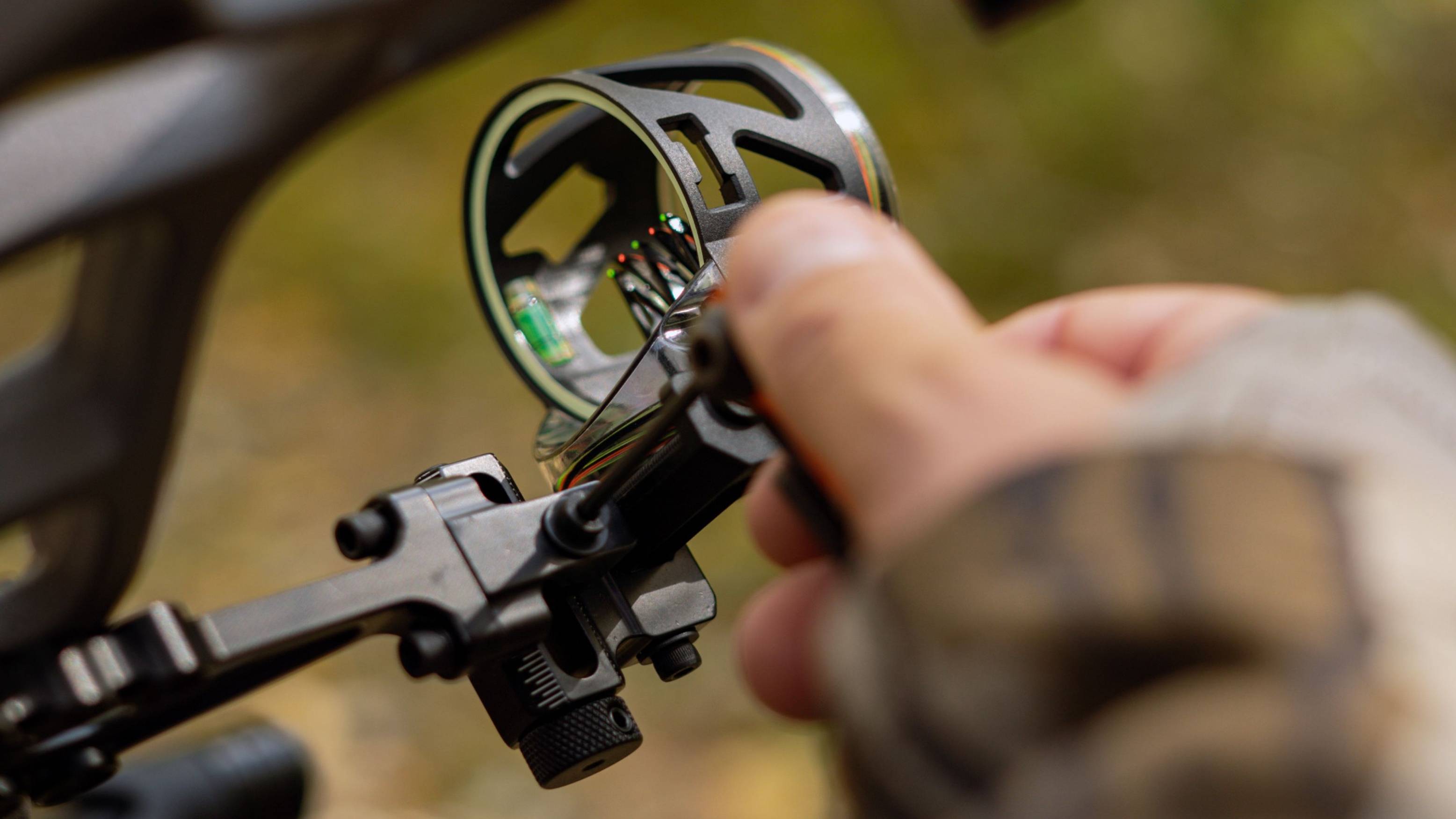 Person adjusting Dimension bow sight from Trophy Ridge. 