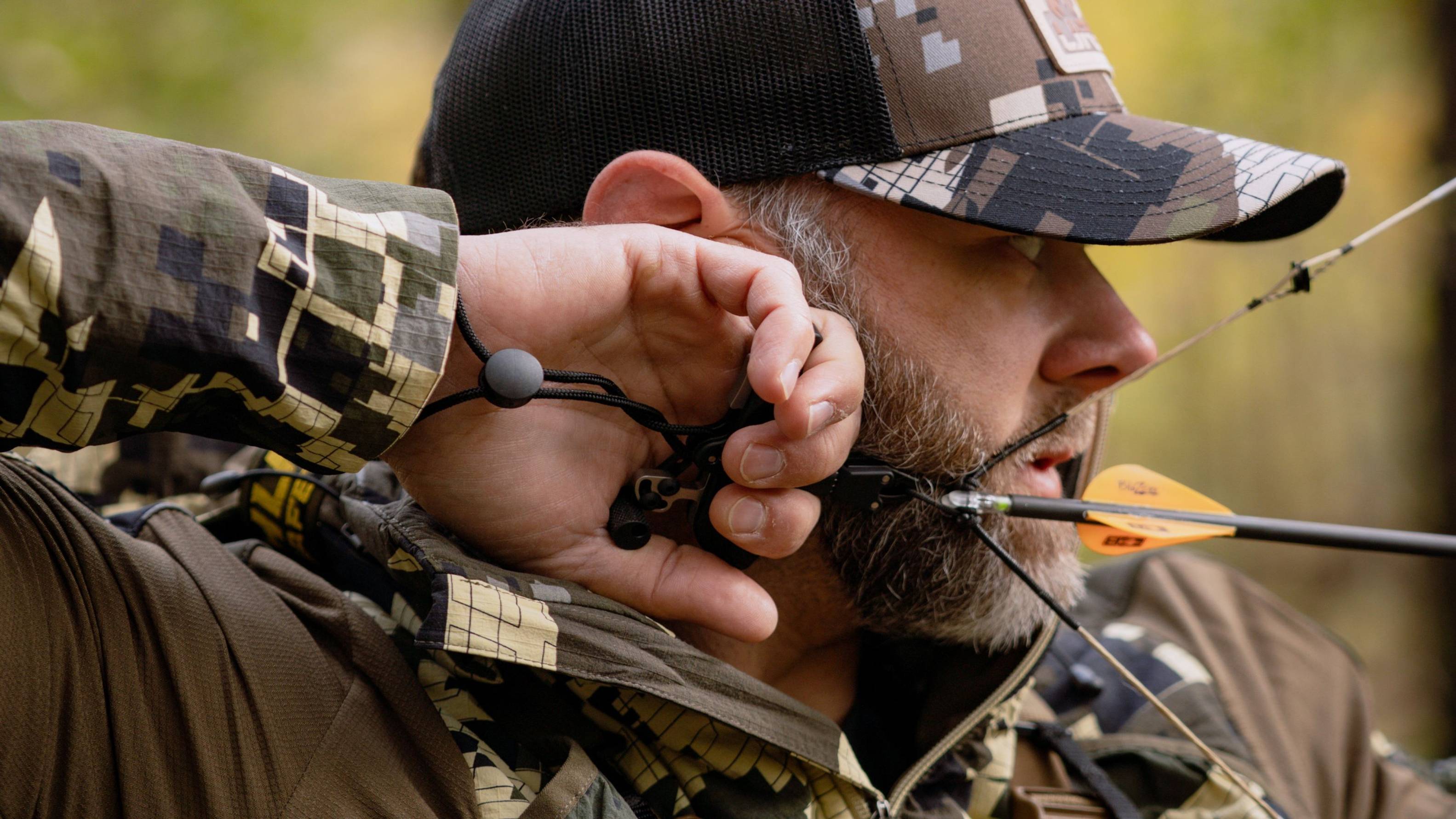 Close up of man using the 3 Finger Precise Pro bow release from Trophy Ridge at full draw.