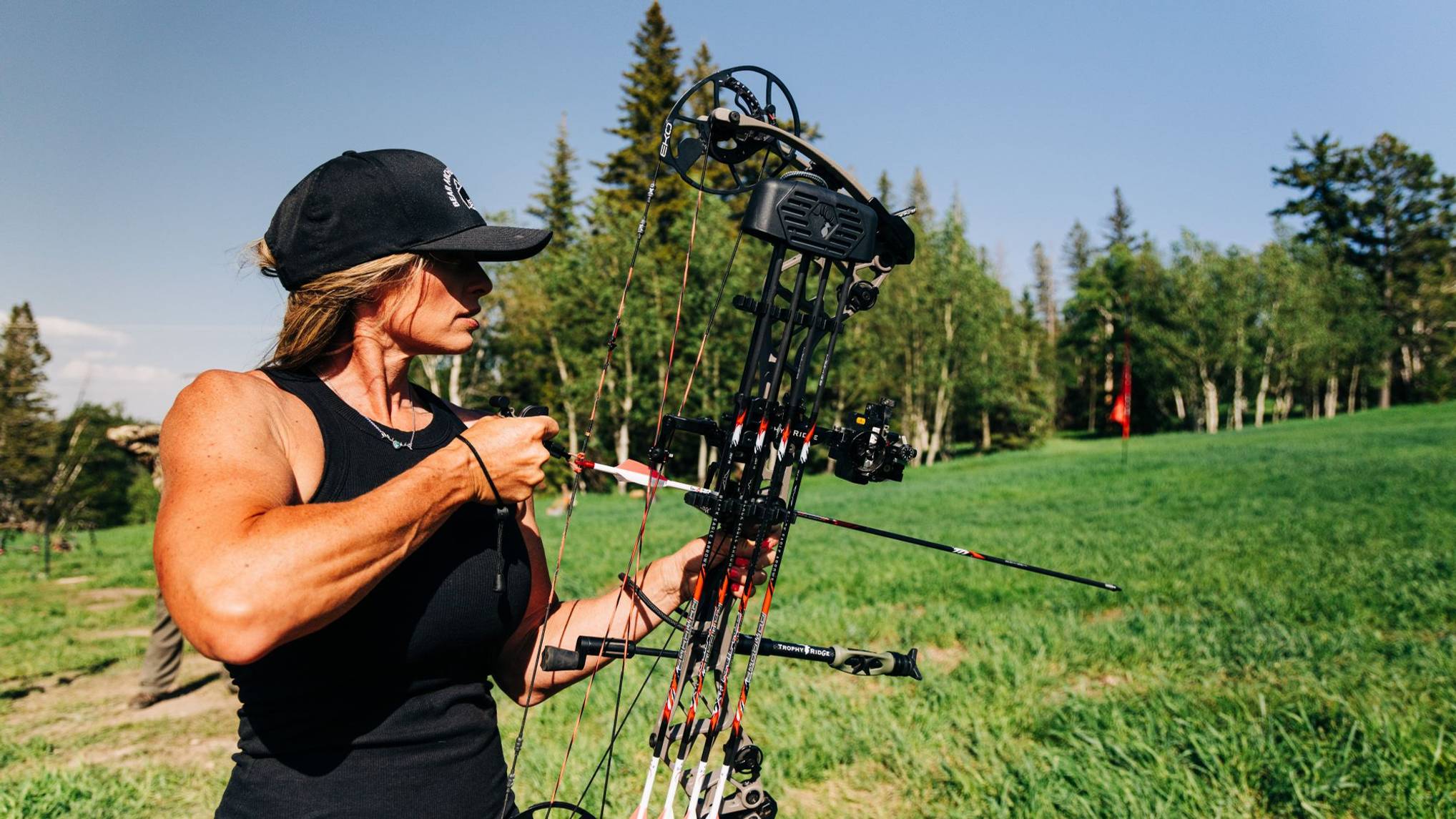 Woman shooting compound bow with Cloak Quiver from Trophy Ridge attached