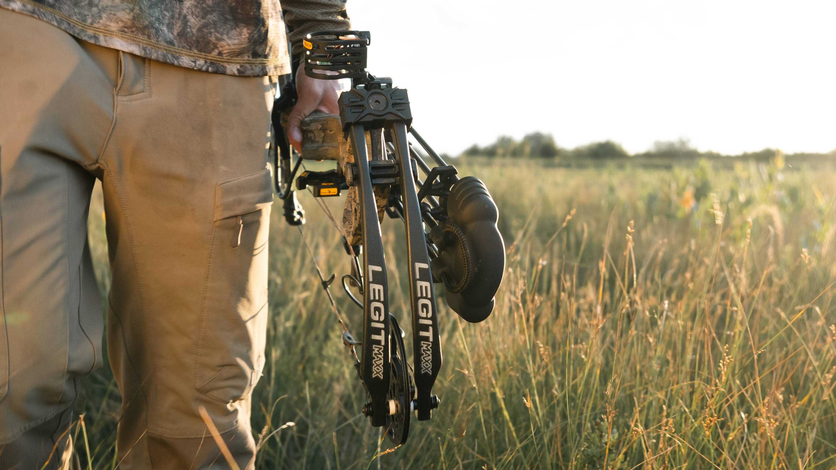 Man carrying a Bear Legit MAXX through a field.