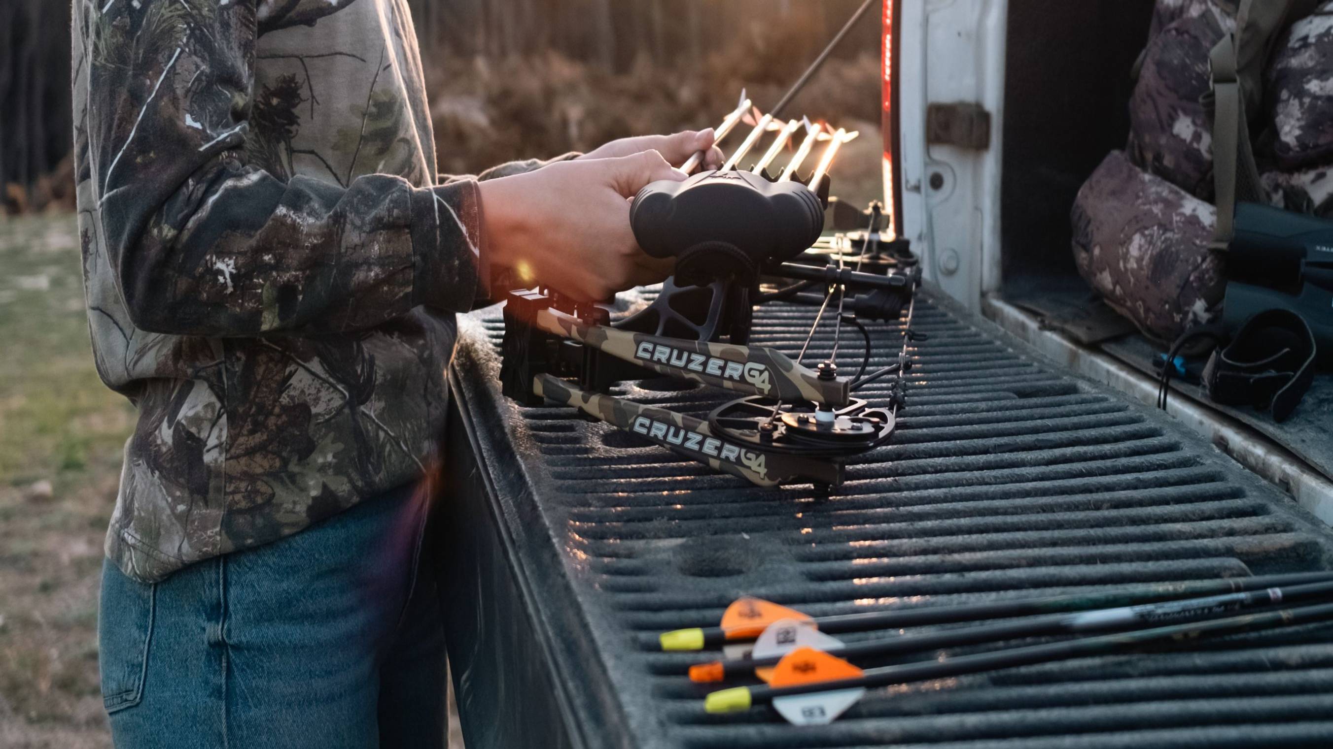 Bear Archery Cruzer G4 compact compound bow laying on a truck bed.