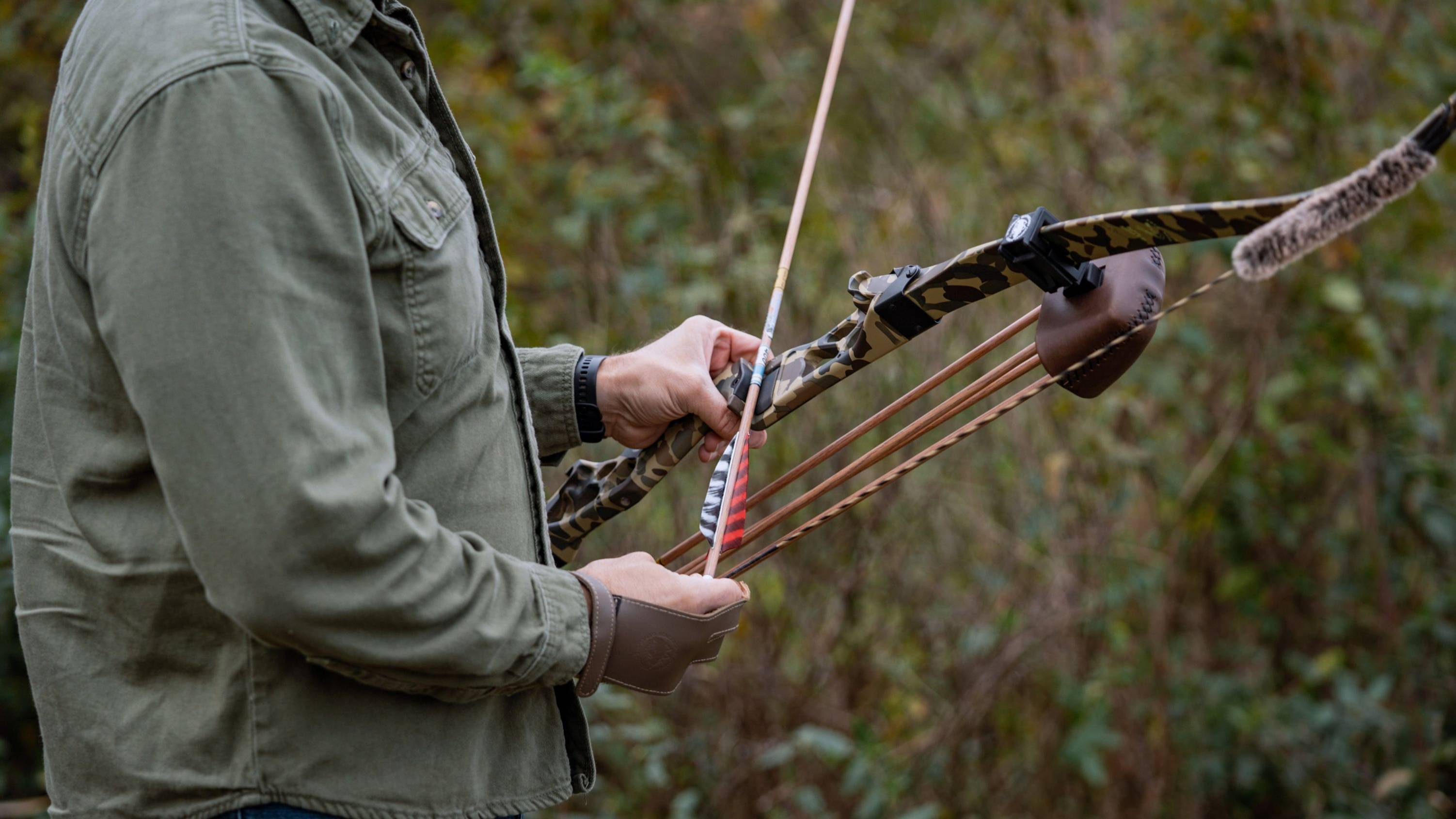 Man knocking an arrow onto the Mag Riser with Fred Bear Camo Take Down Bow Limbs from Bear Archery.