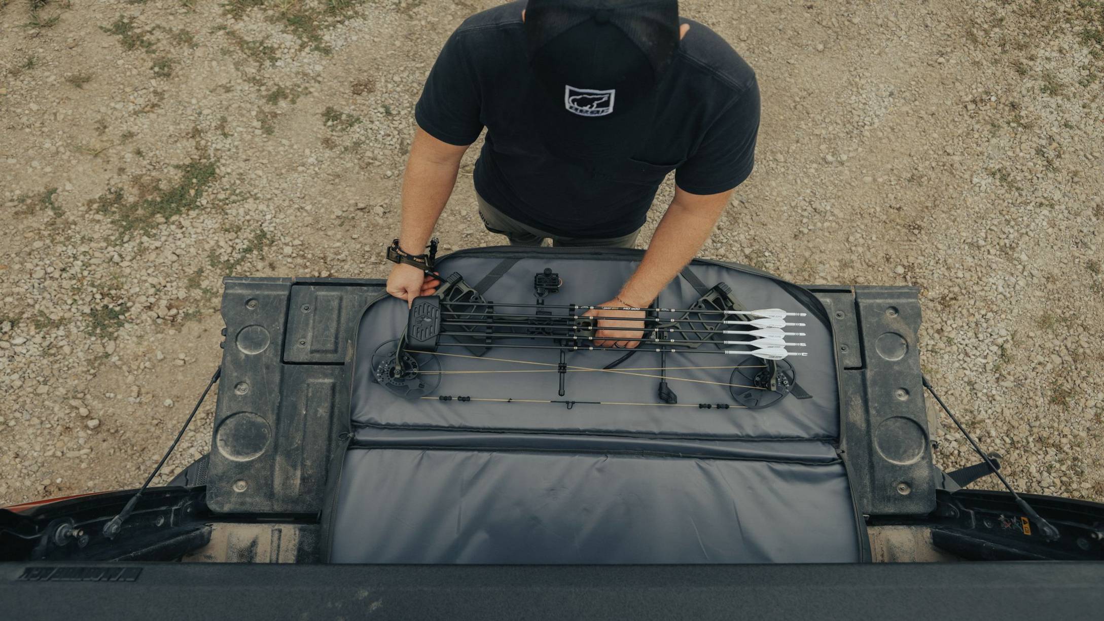 View of man opening the Warrant RTH compound bow from Bear Archery from above.