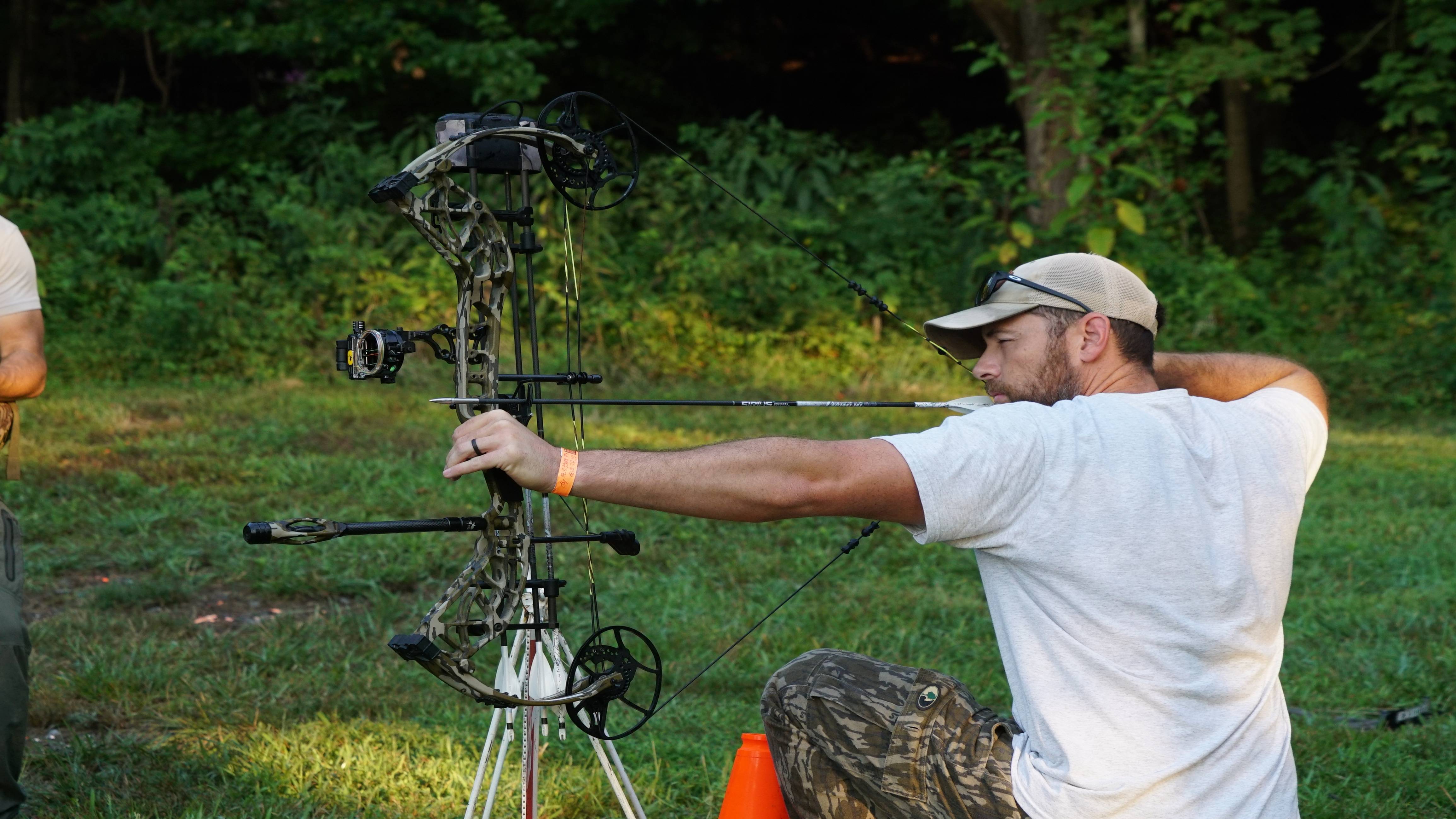 Man shooting a compound bow with the Seismic Quick Connect from Trophy Ridge attached.