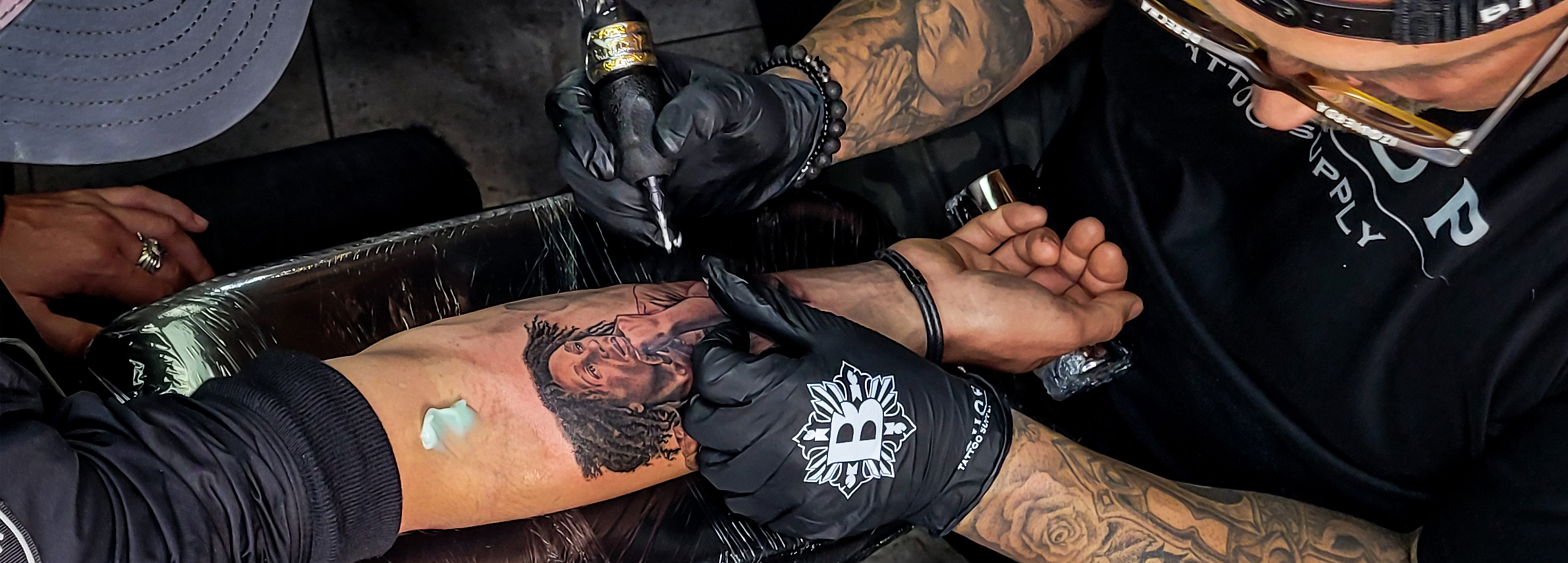 Artist Wearing Gloves Tattooing Design On Human Hand High-Res Stock Photo -  Getty Images
