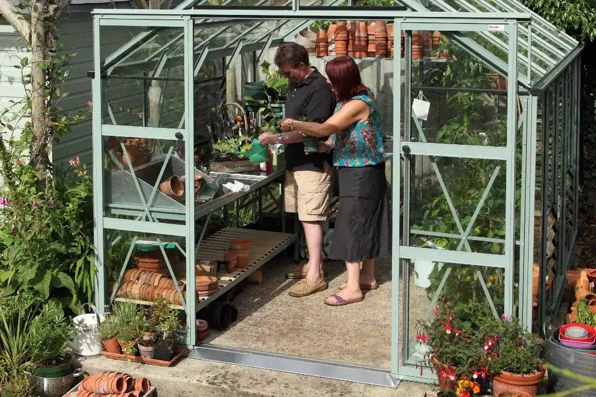 Man and woman in their Rhino greenhouse