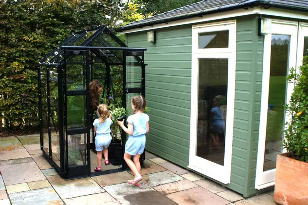 Elite compact 4x4 greenhouse on paving slabs