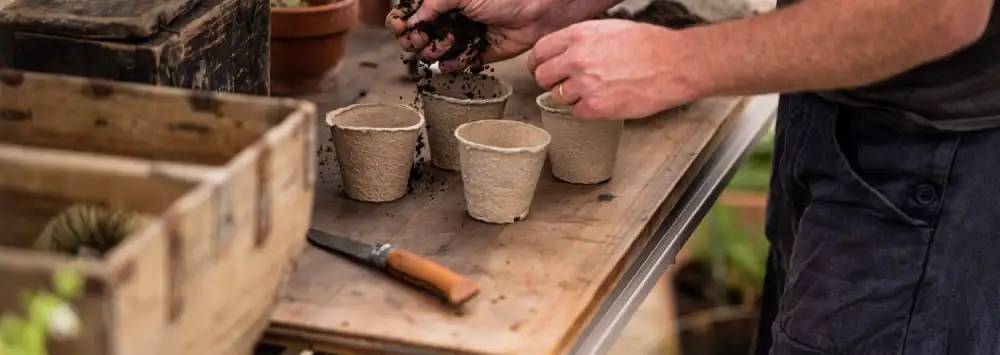 Filling recyclable pots with compost