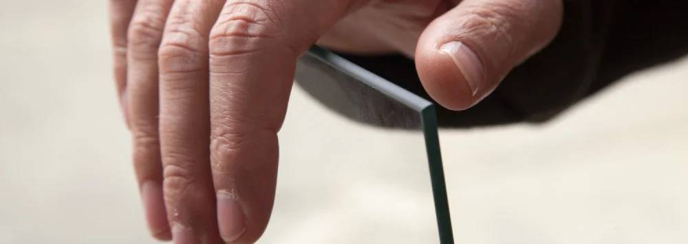 Man holding pane of toughened safety glass