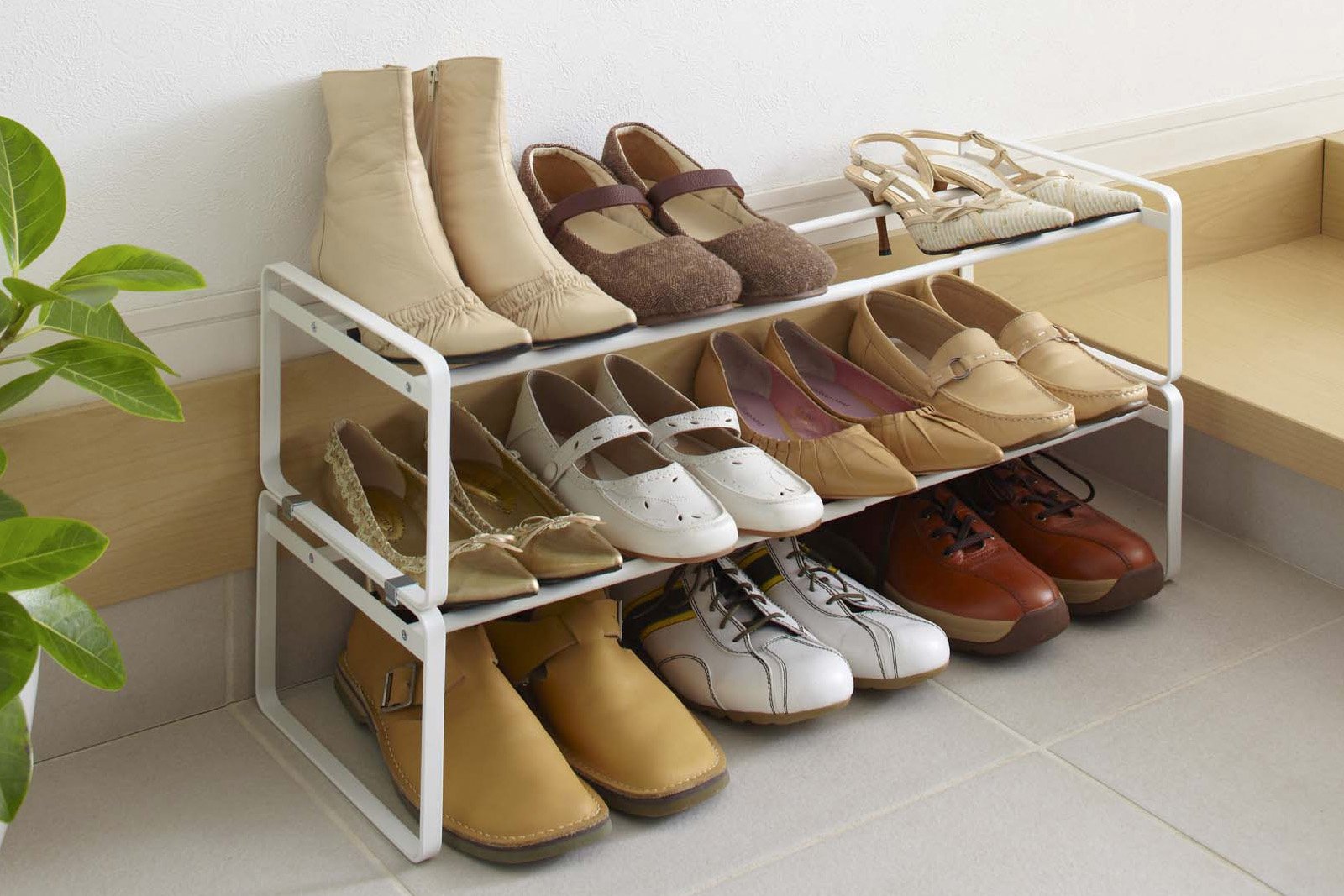Yamazaki Home Stackable Shoe Rack holding shoes in the entryway. 