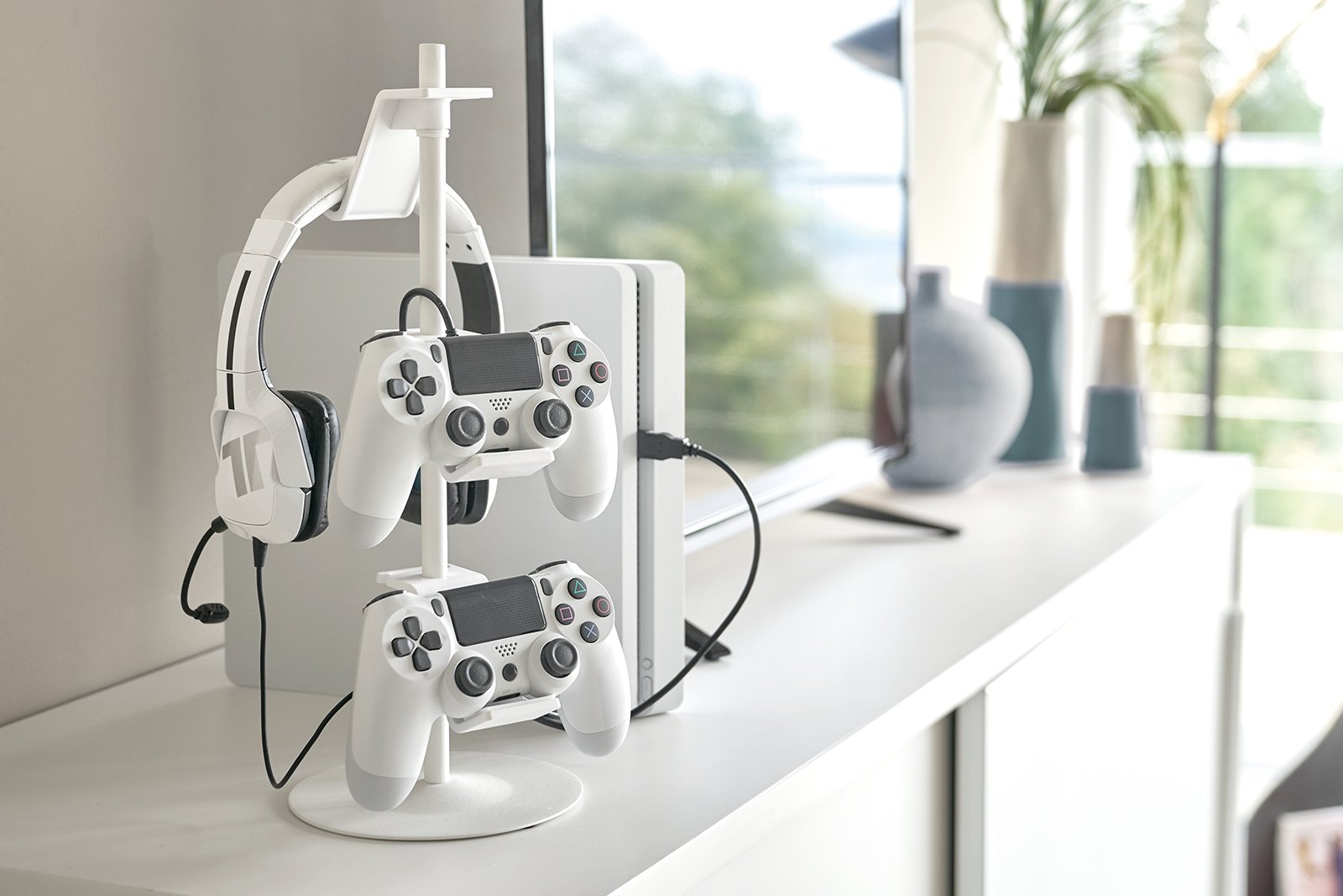 Yamazaki Home white Controller Stand holding two controllers and one headphone on the cabinet. 