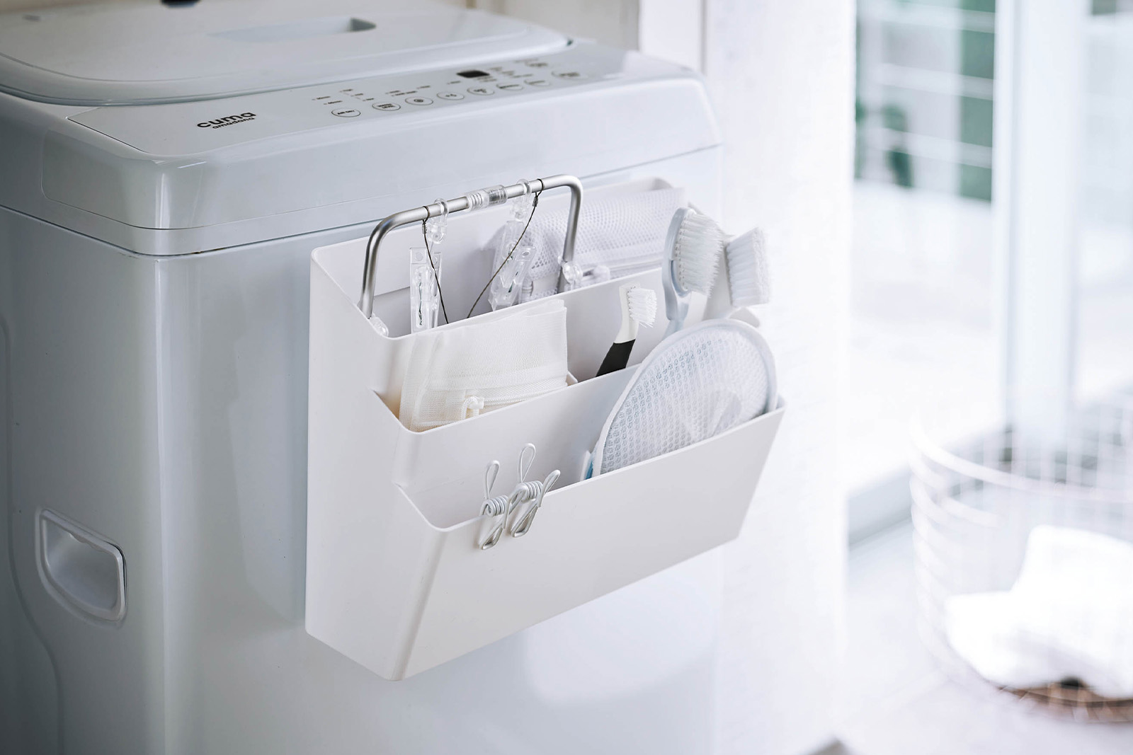Yamazaki Home White Magnetic Storage Caddy holding laundry products. 