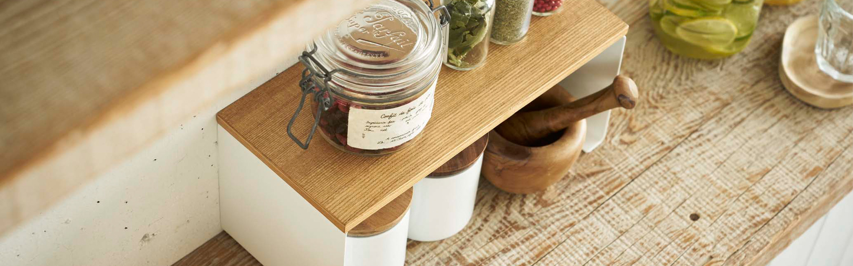 Aerial view of Stackable Countertop Shelf holding spices and bins. 