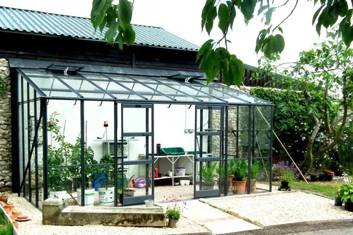 Large lean to greenhouse filled with plants