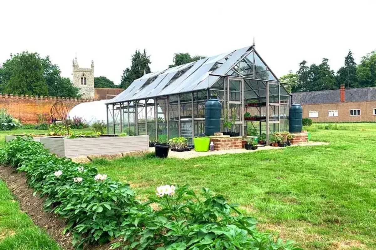 Rhino Greenhouse in large open plan garden
