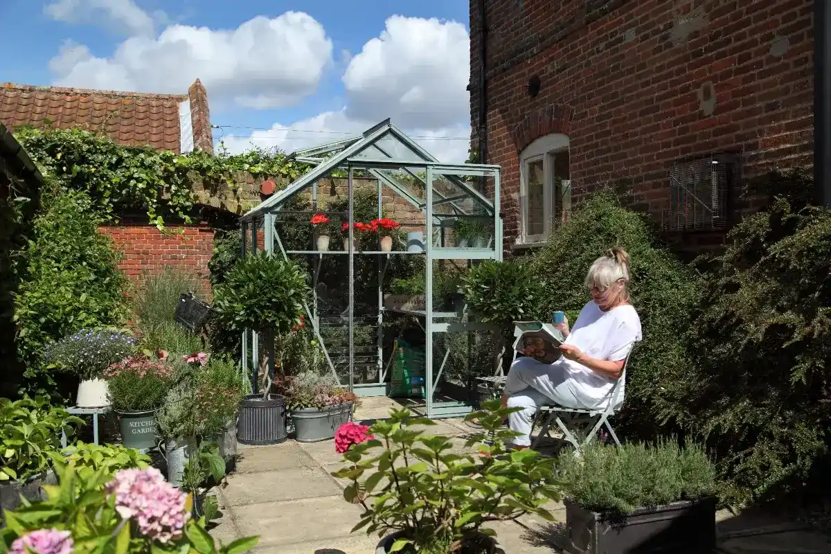 6x4 Rhino greenhouse in a beautifully landscaped garden