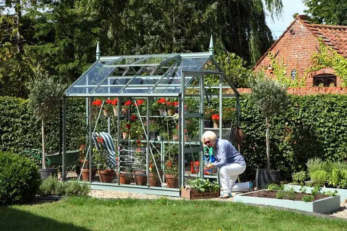 Lady and her Rhino Greenhouse - tending to plants