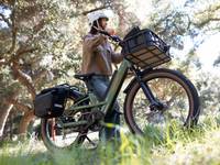 Woman walking her new Radster Trail ebike in a park. 