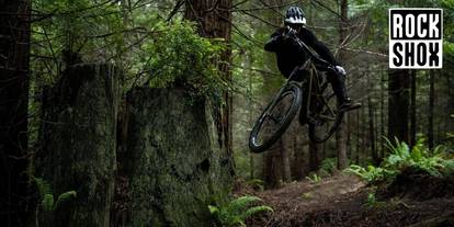 mountain biker riding in a forest background