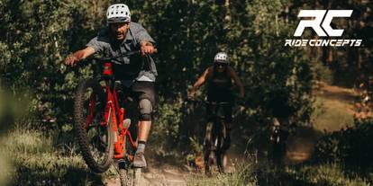 Man riding an electric mountain bike and ride concepts logo on the top right