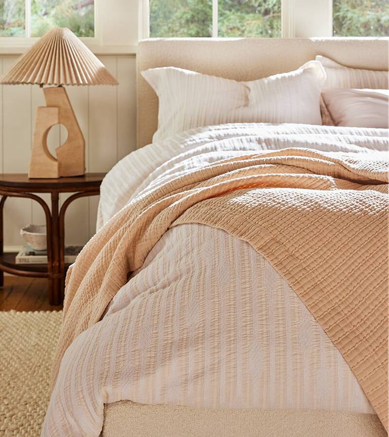 Brooklinen Woven Textured Cotton Bedding in Soft Oat on a Bed