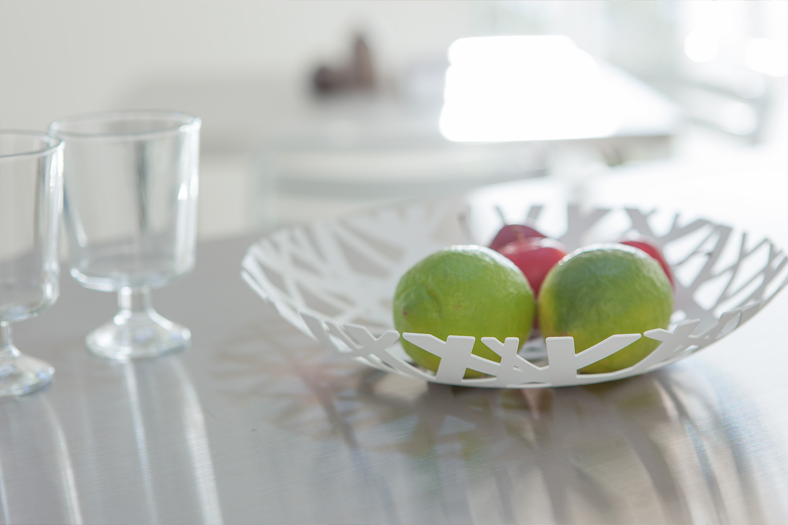 Yamazaki Home Fruit Bowl holding limes on the kitchen countertop. 