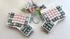 DSA Witch girl keycaps on white ErgoDox EZ ergonomic keyboard photographed with matching flowers and cable.
