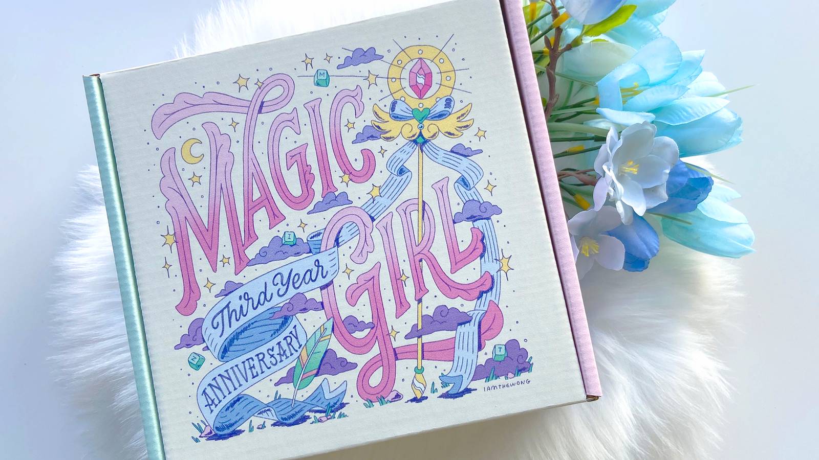 Magic Girl by Mintlodica lettering artwork by illustrator Matthew Wong celebration the third anniversary collectibles including boxes, postcards, and stickers. Featuing cute ribbons, wings, magic staff, moons, stars, and a feather.