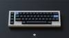 DSS Sad Girl keycaps render. Designed by Mintlodica. Blue Accent Enter and top left key featuring new legend icons shown on small 40% layout keyboard.