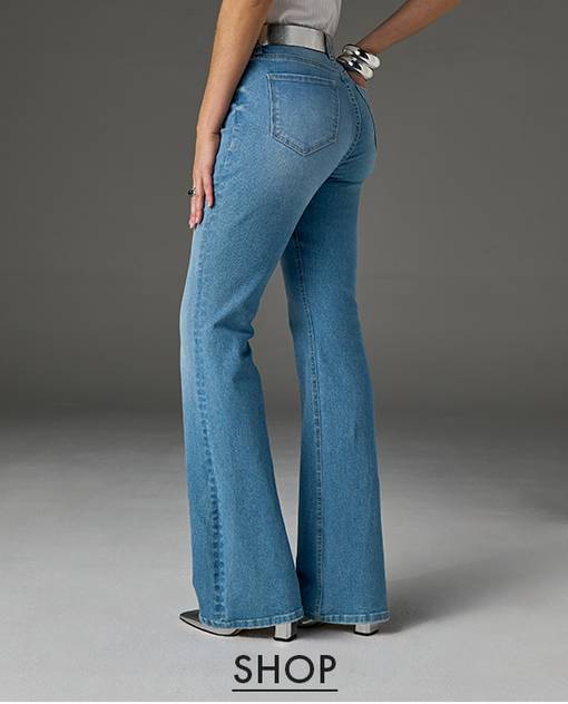 Model is wearing light wash bootcut jeans.