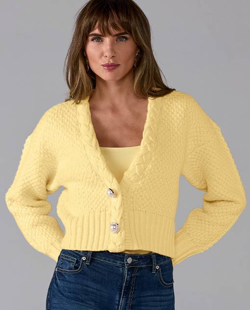 Models wearing a yellow tank and sweater.